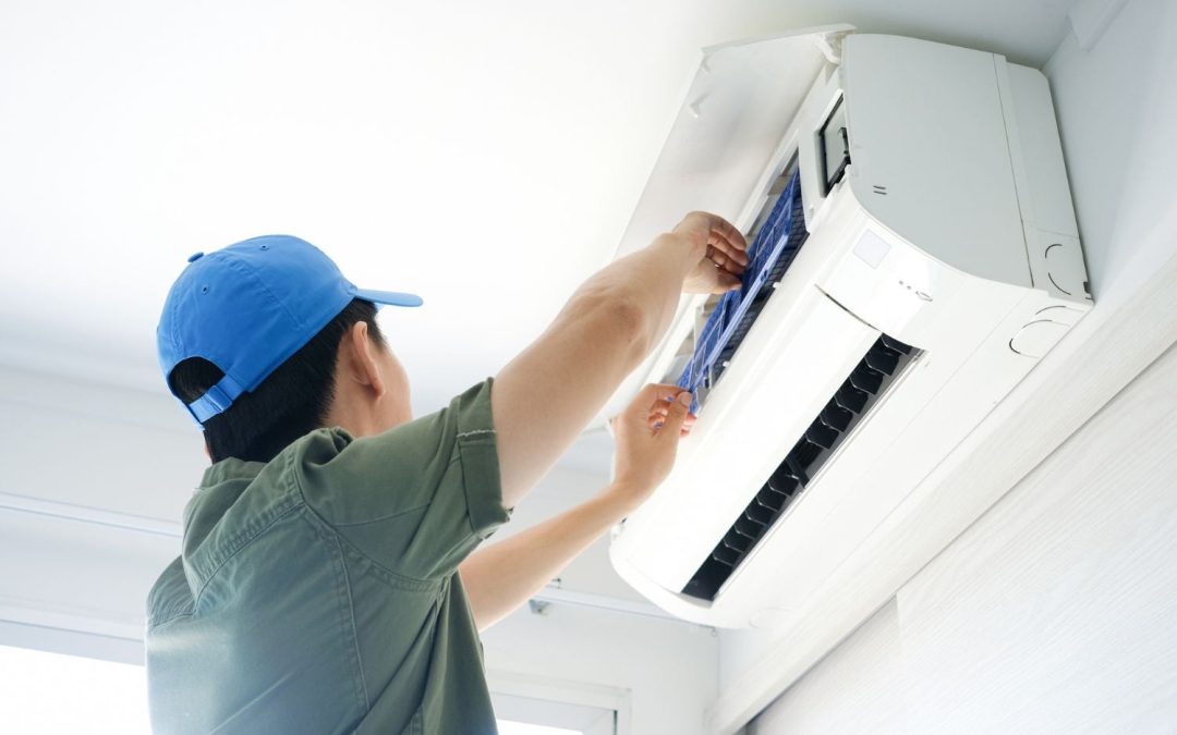 Air conditioning technician maintaining an indoor mini split system in Bullhead City, AZ