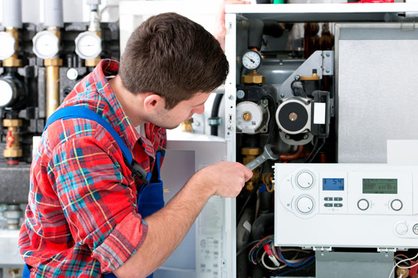 HVAC technician inspecting an indoor heating system in Bullhead City, AZ