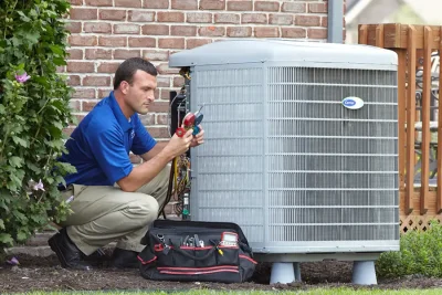 design-air-heating-and-air-conditioning-decatur-il-05 – Copy HVAC technician inspecting an outdoor air conditioning unit in Bullhead City, AZ